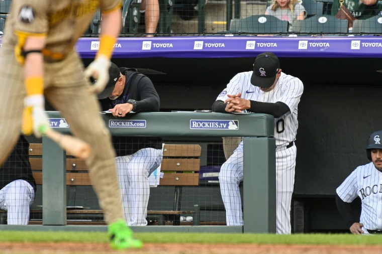 Bud Black stands on the top step of the dugout with his head down