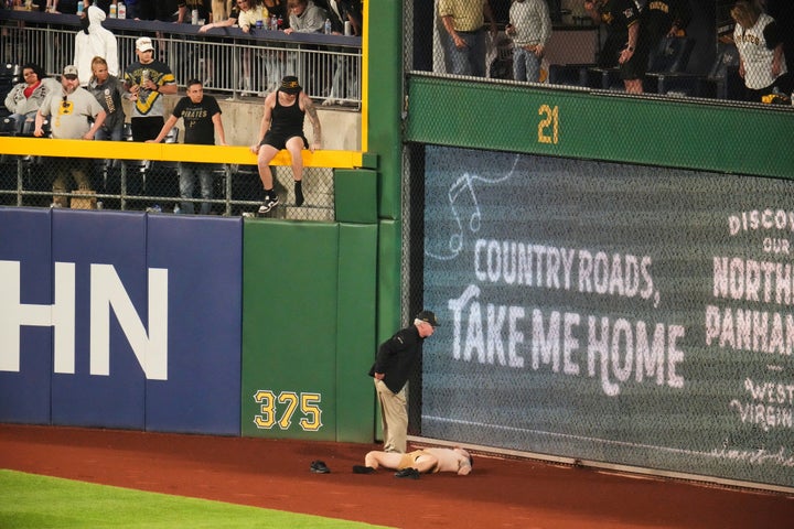 Markwood lies on the warning track after plunging from the stands.