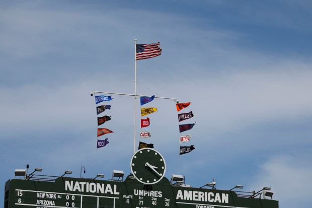 The Chicago Cubs flag flies in first place atop the scoreboard Wednesday, May 7, 2025, at Wrigley Field. (Brian Cassella/Chicago Tribune)