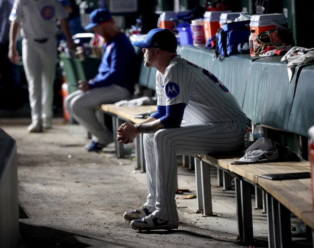 Cubs reliever Ryan Pressly sits in the dugout after being pulled in the 11th inning against the Giants on May 6, 2025, at Wrigley Field. (Chris Sweda/Chicago Tribune)