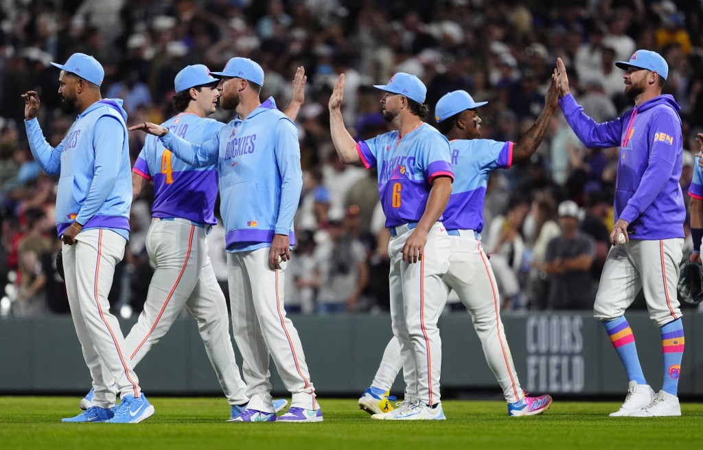 Rockies players celebrate after their win over the Yankees, their ninth of the season.