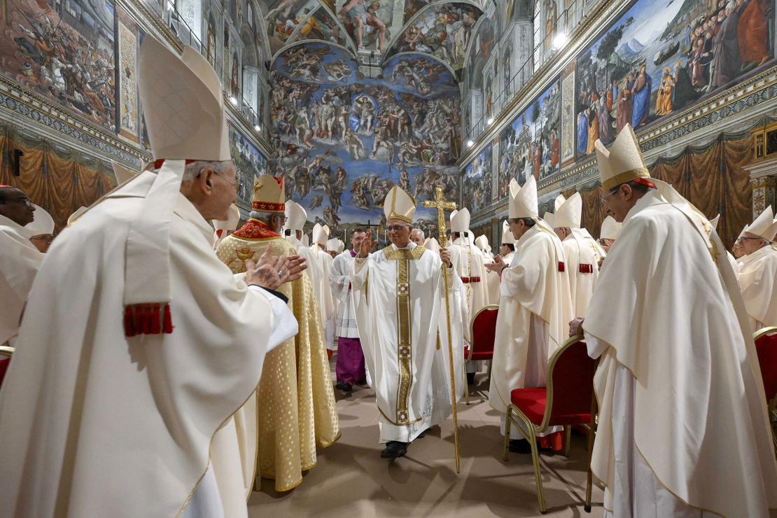 Leo XIV leaves the Sistine Chapel after leading his first Mass as pope on Friday.