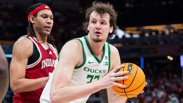 Mar 13, 2025; Indianapolis, IN, USA; Oregon Ducks center Nate Bittle (32) holds the ball while Indiana Hoosiers forward Malik