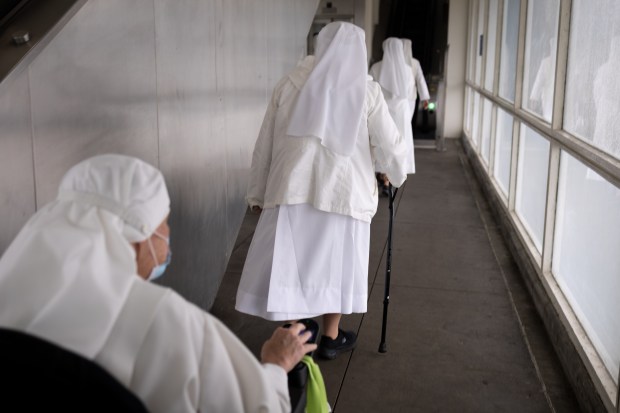 Members of Little Sisters of the Poor exit the Red Line before making their way to Rate Field as Chicago celebrates the election of Pope Leo XIV with a citywide gathering and Catholic Mass on June 14, 2025. (Audrey Richardson/Chicago Tribune)