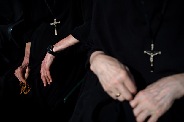 Sister Natanaela, with Missionary Sisters of St. Benedict, holds rosary beads while celebrating the election of Pope Leo XIV with a citywide gathering at Rate Field on June 14, 2025. (Audrey Richardson/Chicago Tribune)