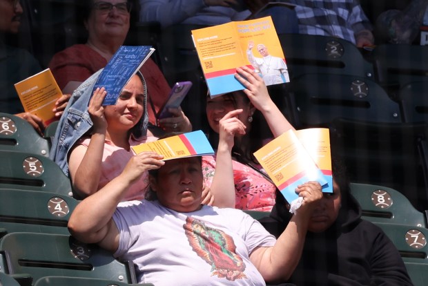 Faithful attend a mass and a celebration of the election of Pope Leo XIV on June 14th, 2025, at Rate Field. (Antonio Perez/Chicago Tribune)