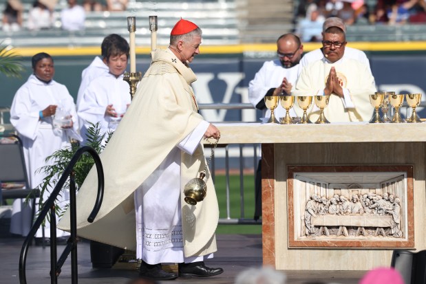 Cardinal Blase Cupich blesses the alter with insence as hundreds of people, take part in a Mass at Rate Field on June 14th, 2025. (Antonio Perez/Chicago Tribune)