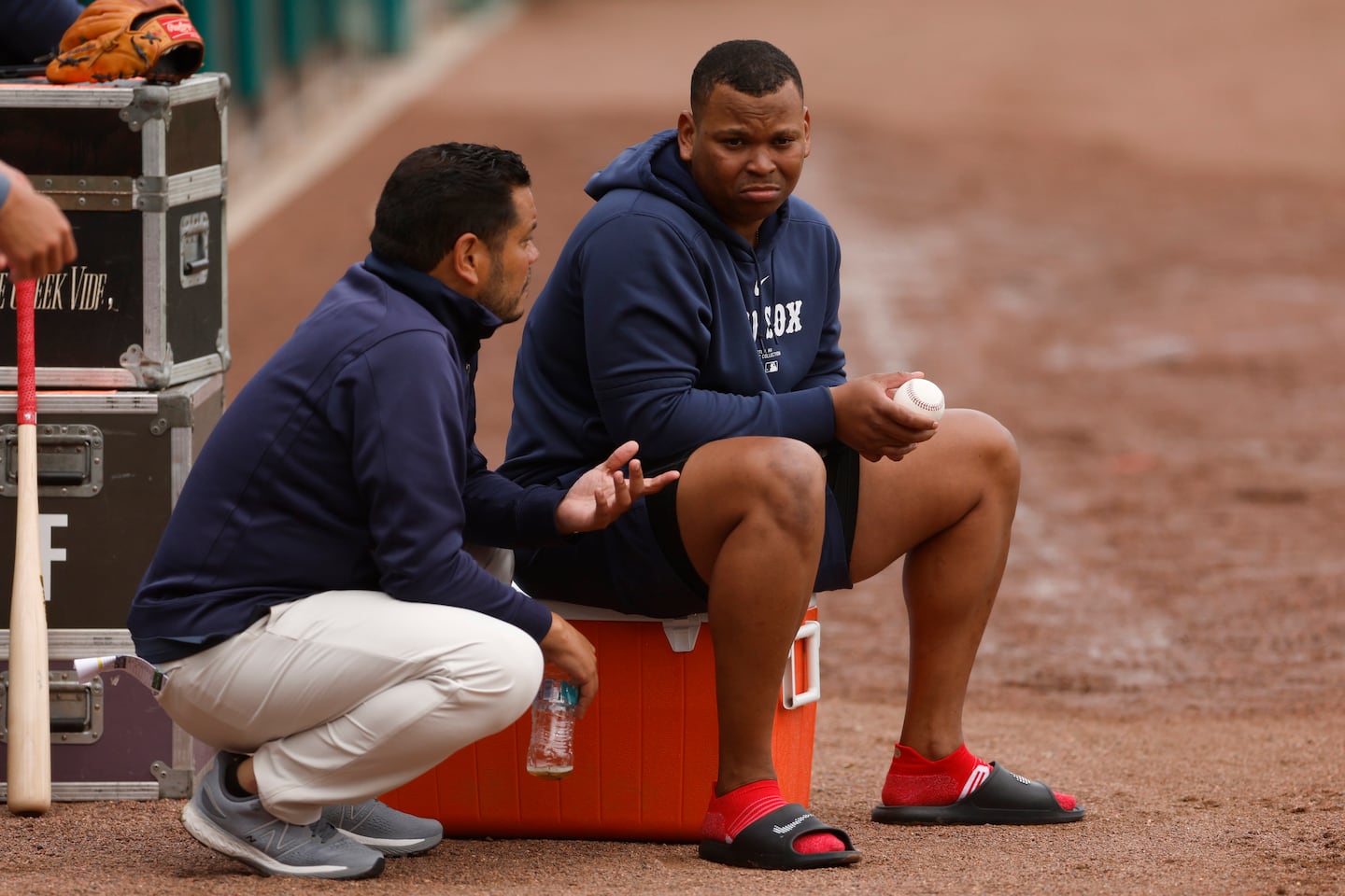 Rafael Devers (right), speaking with assistant general manager Eddie Romero, made it clear that he saw himself as the Red Sox' third baseman, even after the team signed Alex Bregman.